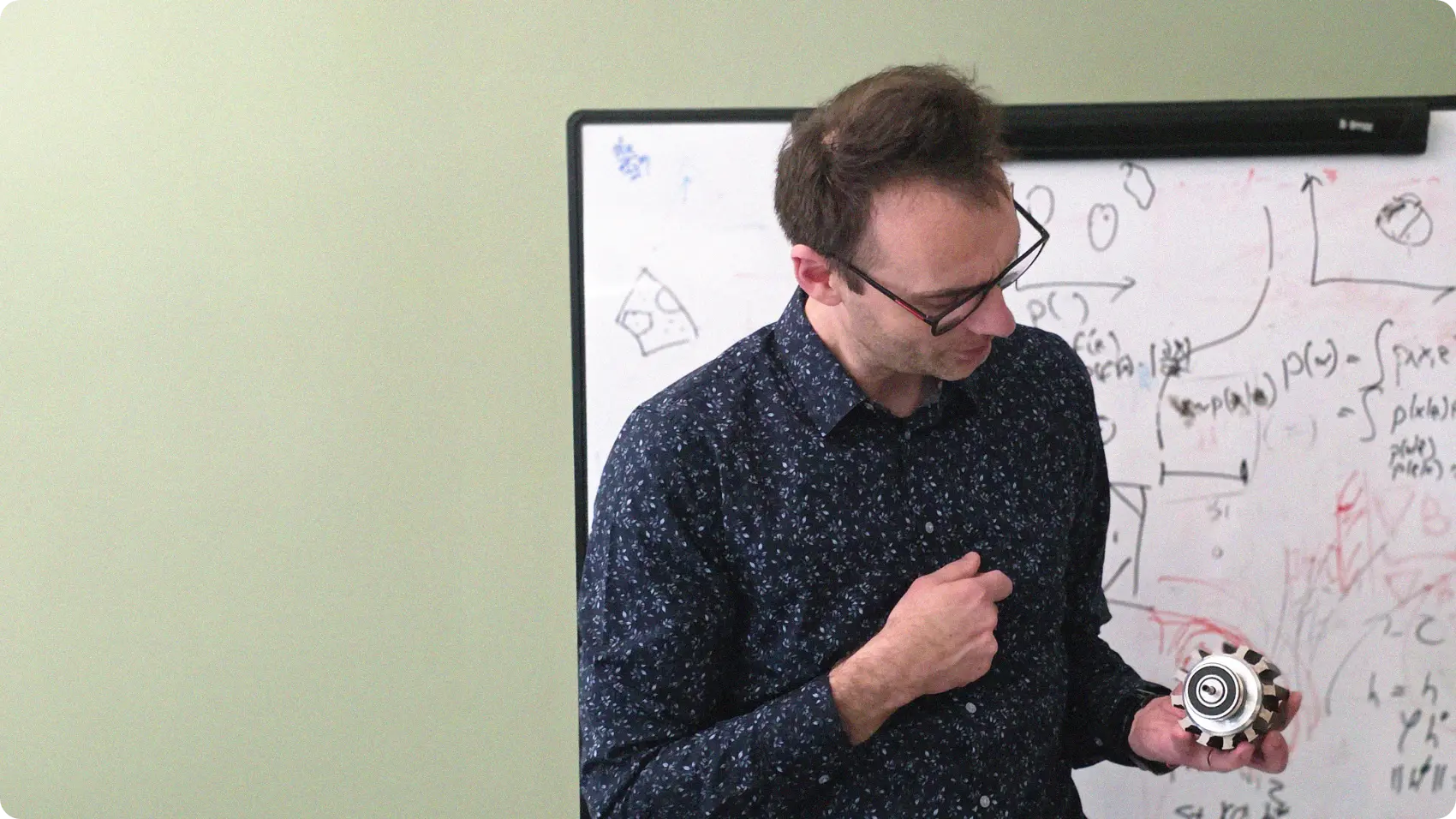 Dr. Jaroslaw Rzepecki explaining while holding a motor