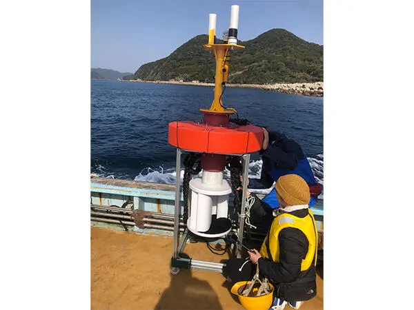 The research team preparing the buoy. 