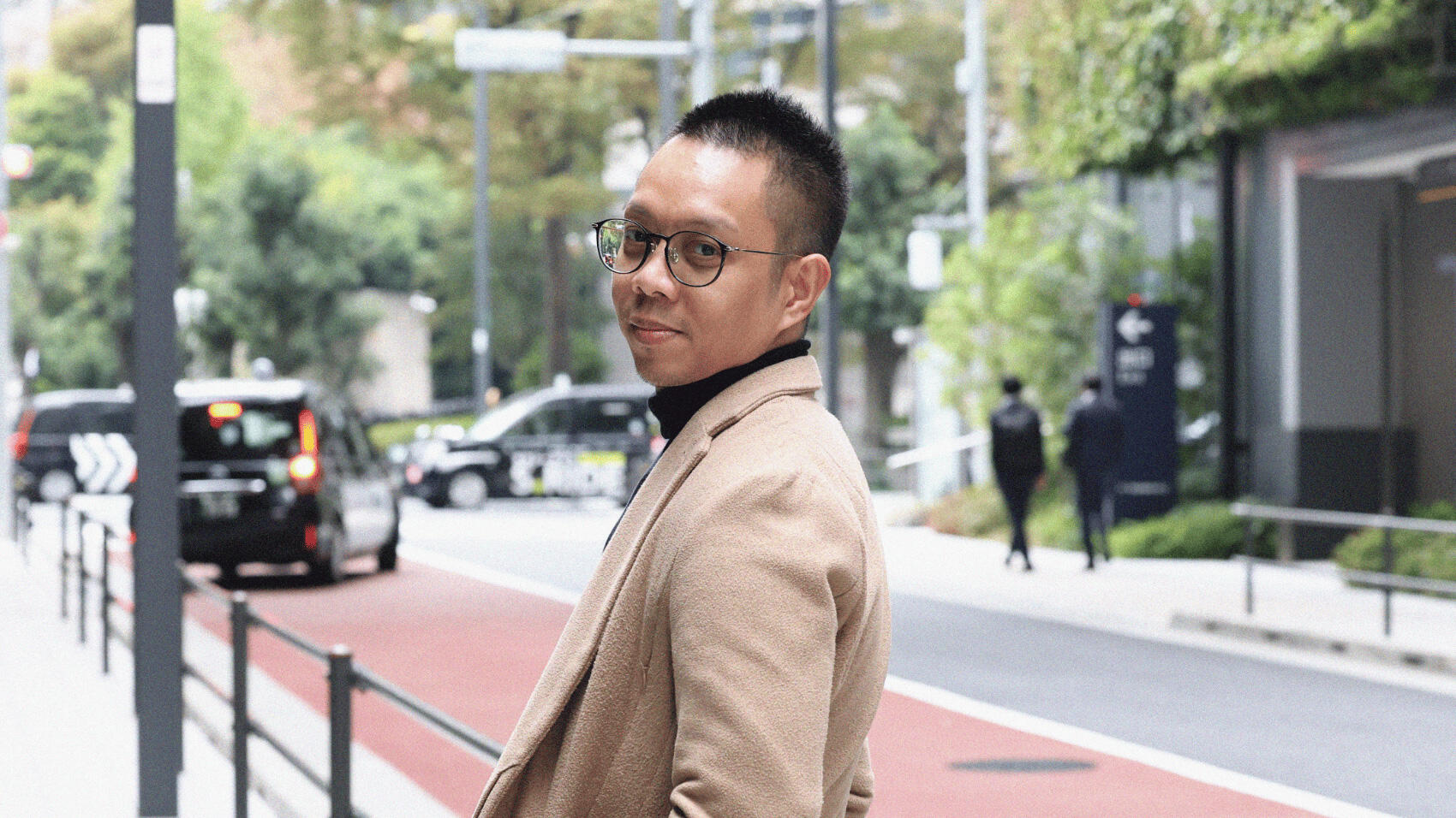 Erwin smiles as he looks back.