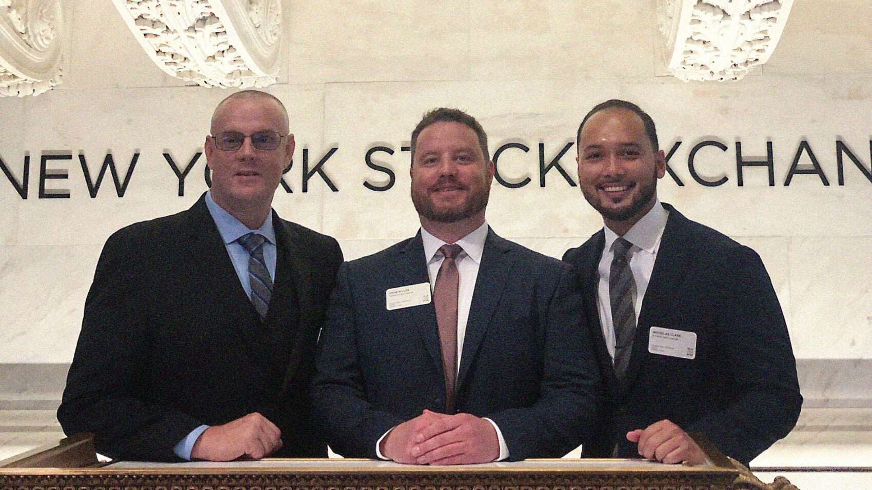 Three smiling Velo3D team members