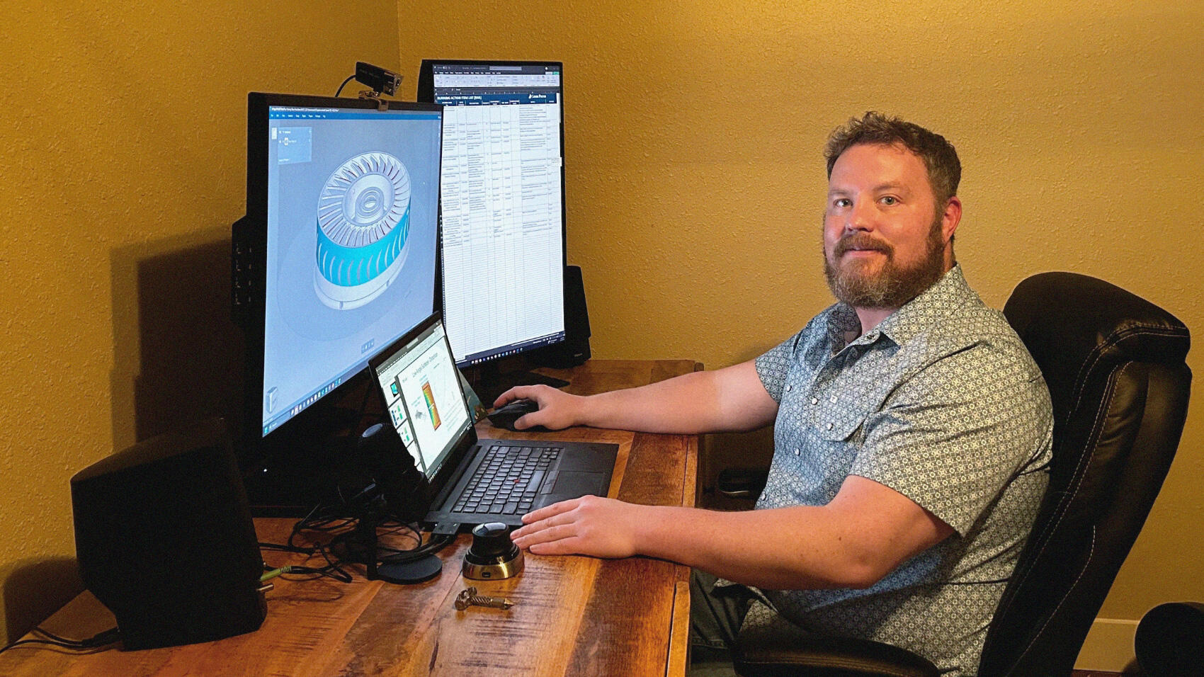 A smiling Gene at work at his desk
